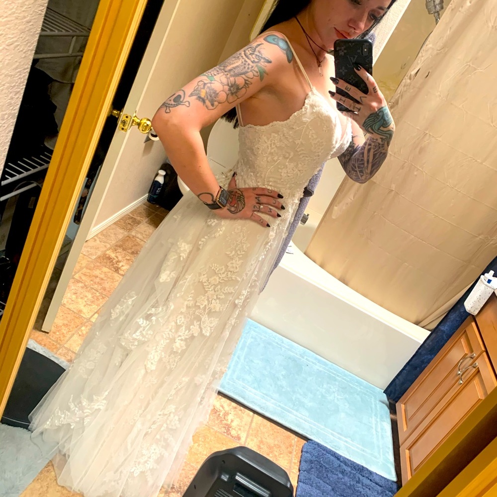 Fitted off white/pink wedding dress with custom bustle from David’s bridal